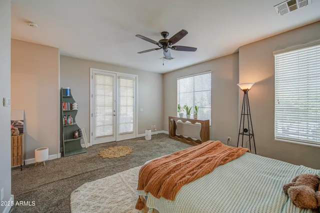 a bedroom with a large bed and a chandelier