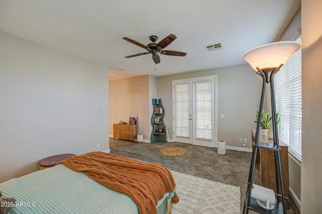 a bedroom with a bed and a large window