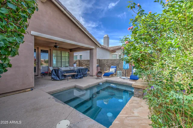 a view of a house with backyard porch and sitting area