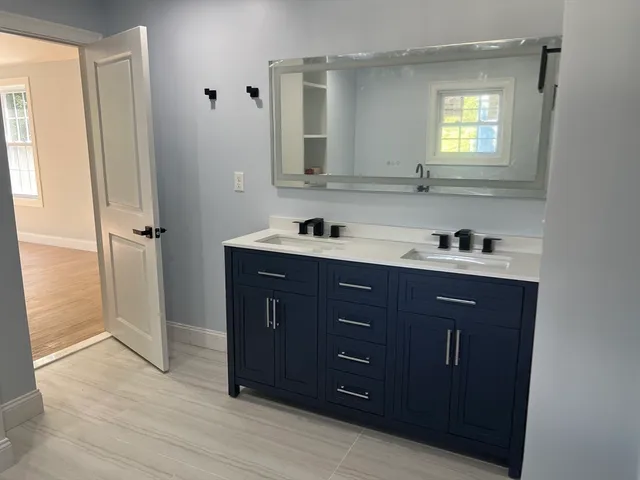 a bathroom with a sink vanity and mirror