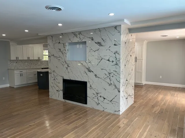 wooden floor in an empty room with a fireplace