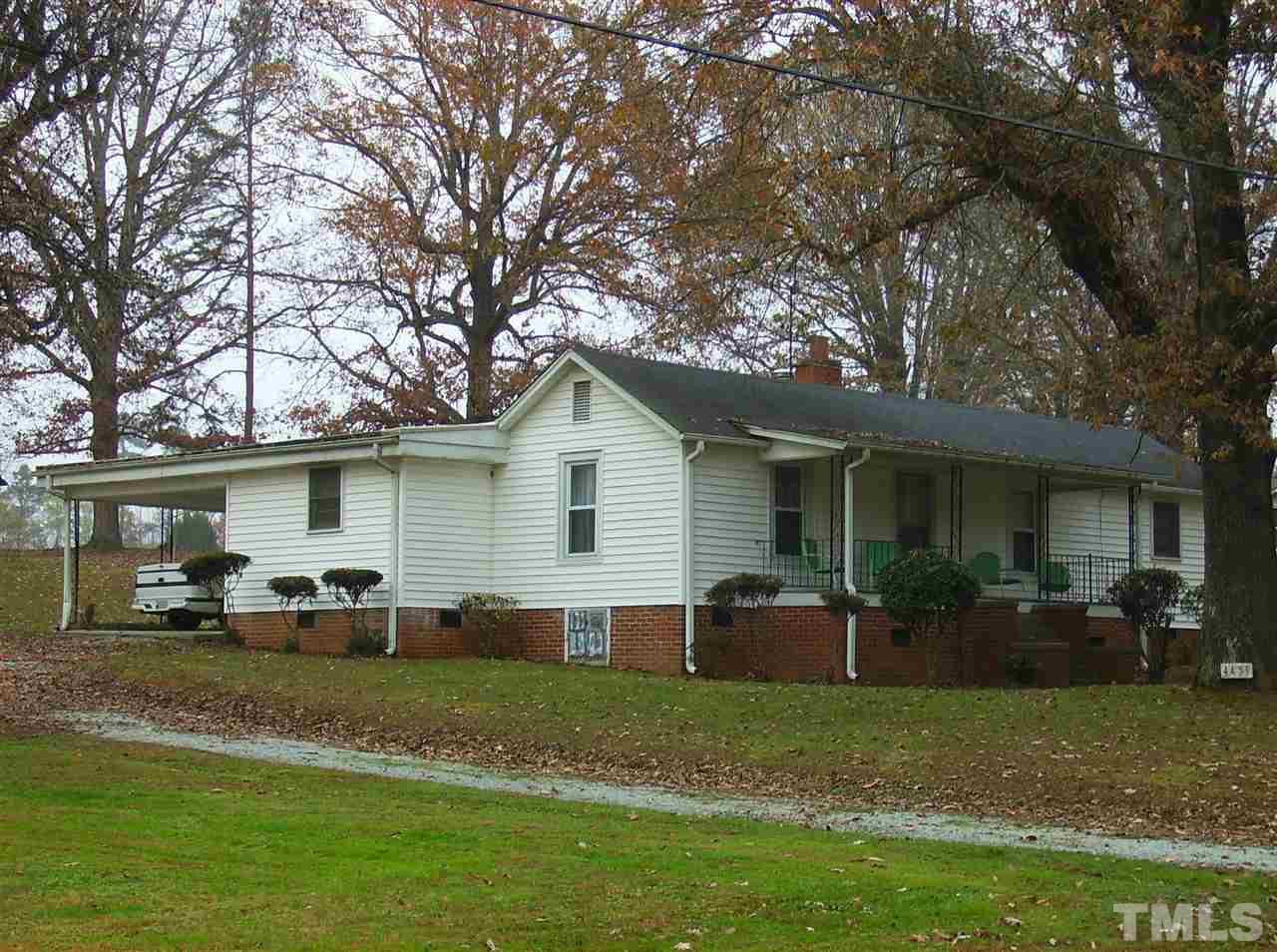 4455 Oxford Road Roxboro, NC 27574 - Photo 1 of 10 a front view of house with a garden and patio