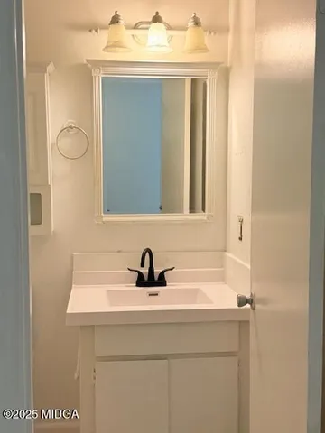 a bathroom with a sink and a mirror