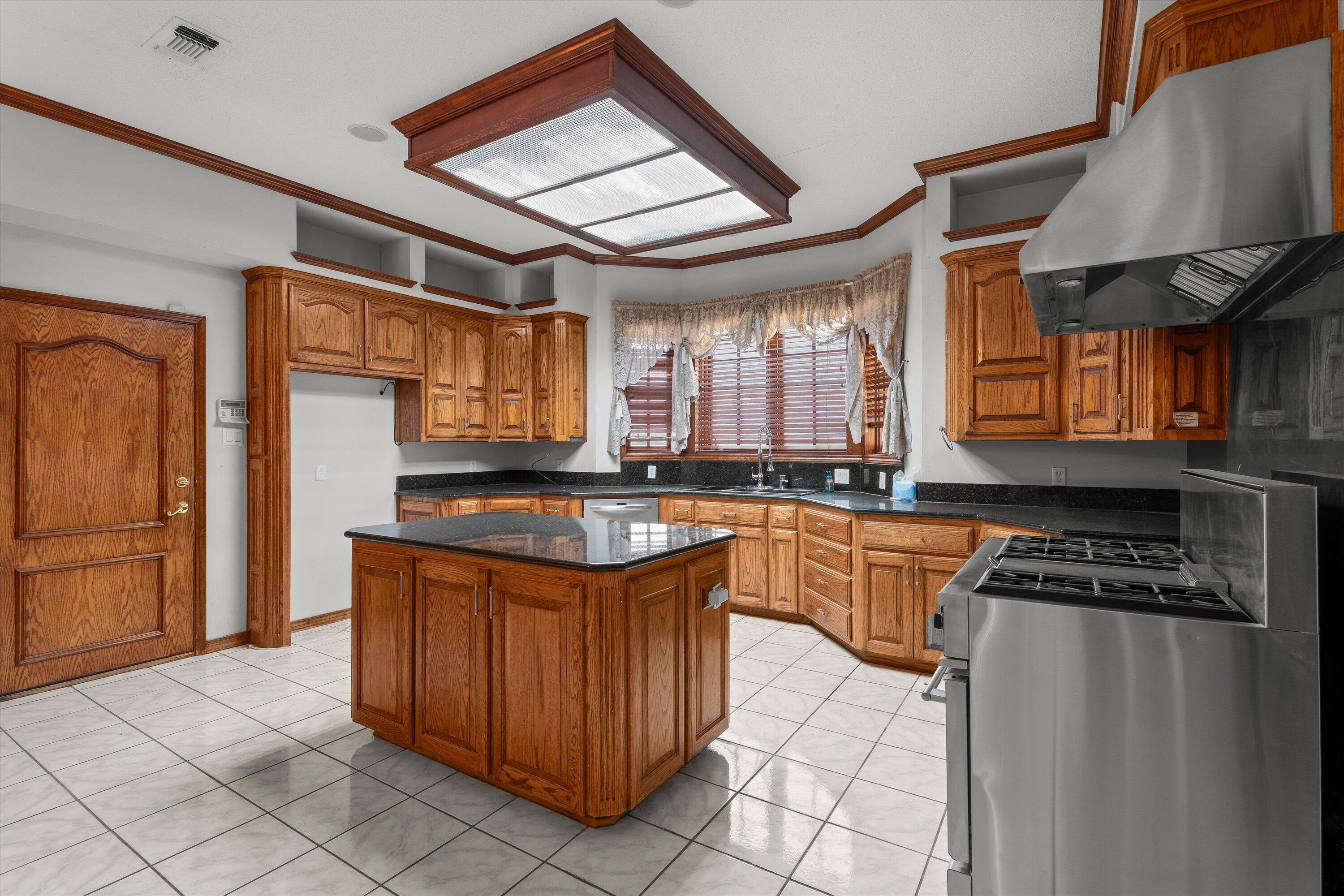 2404 York Avenue Lubbock, TX 79407 - Photo 12 of 88 a kitchen with stainless steel appliances granite countertop a stove a sink and a refrigerator