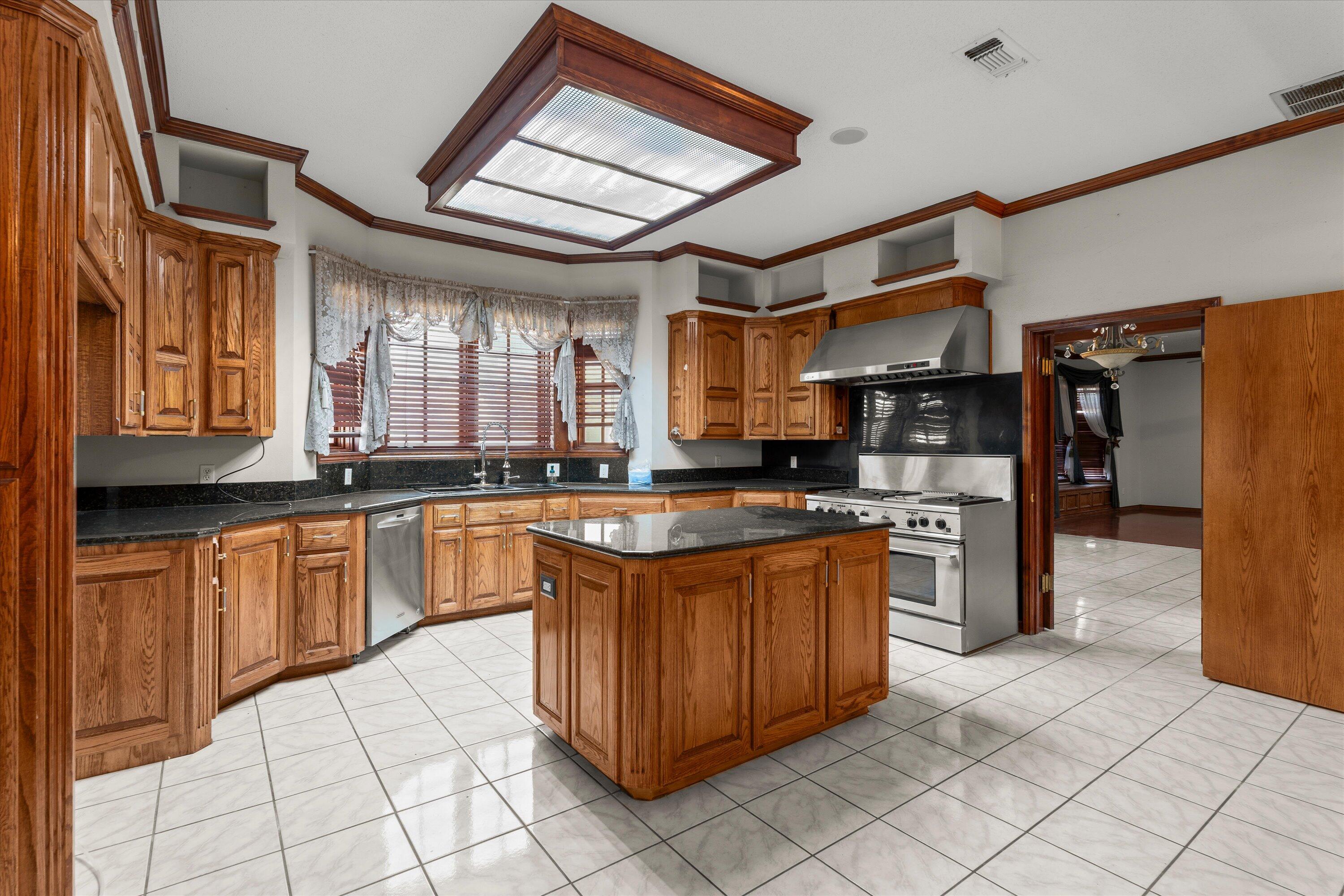 2404 York Avenue Lubbock, TX 79407 - Photo 13 of 88 a large kitchen with stainless steel appliances granite countertop a stove and a refrigerator