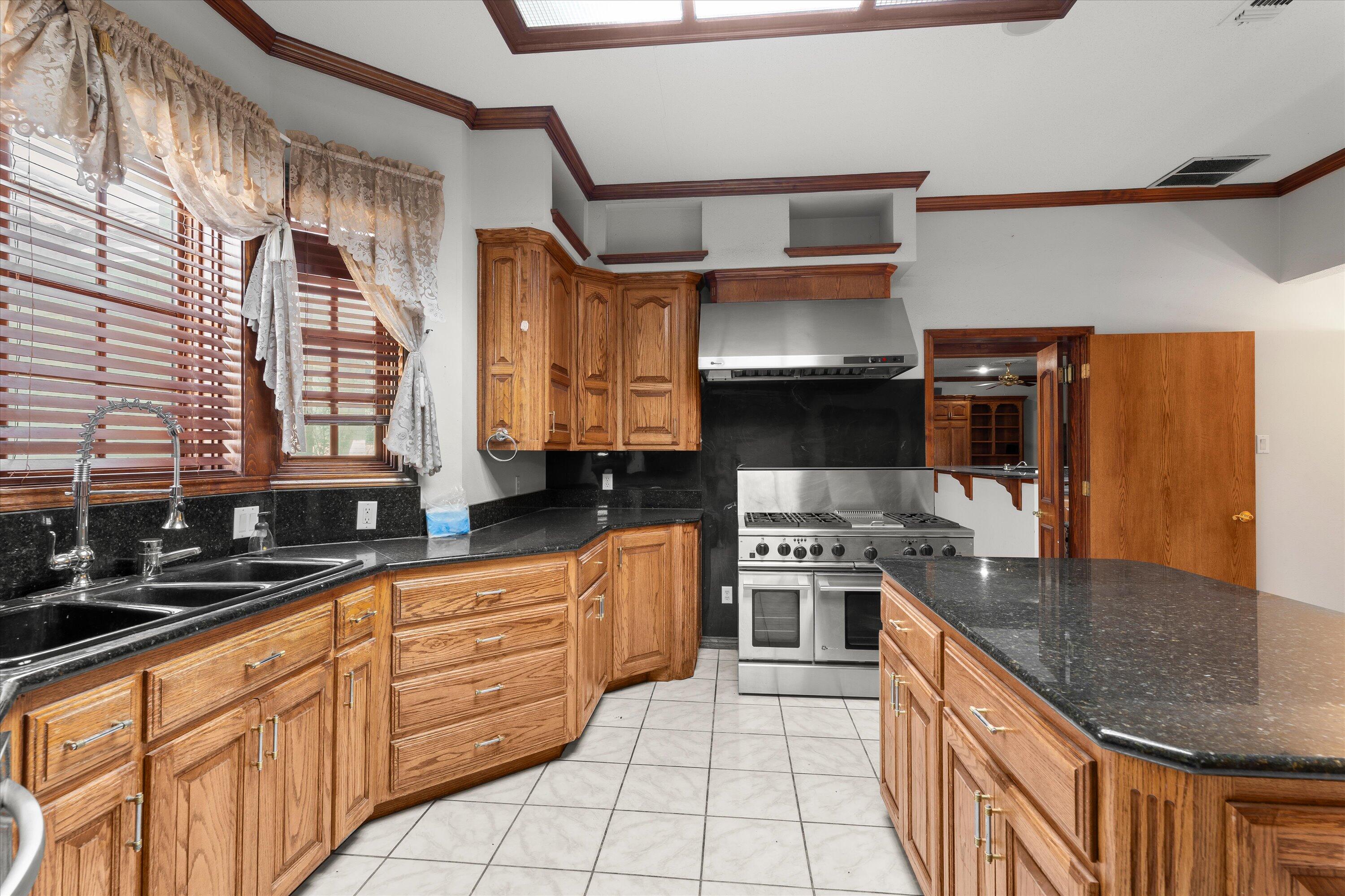 2404 York Avenue Lubbock, TX 79407 - Photo 16 of 88 a kitchen with stainless steel appliances granite countertop a stove a sink and a microwave