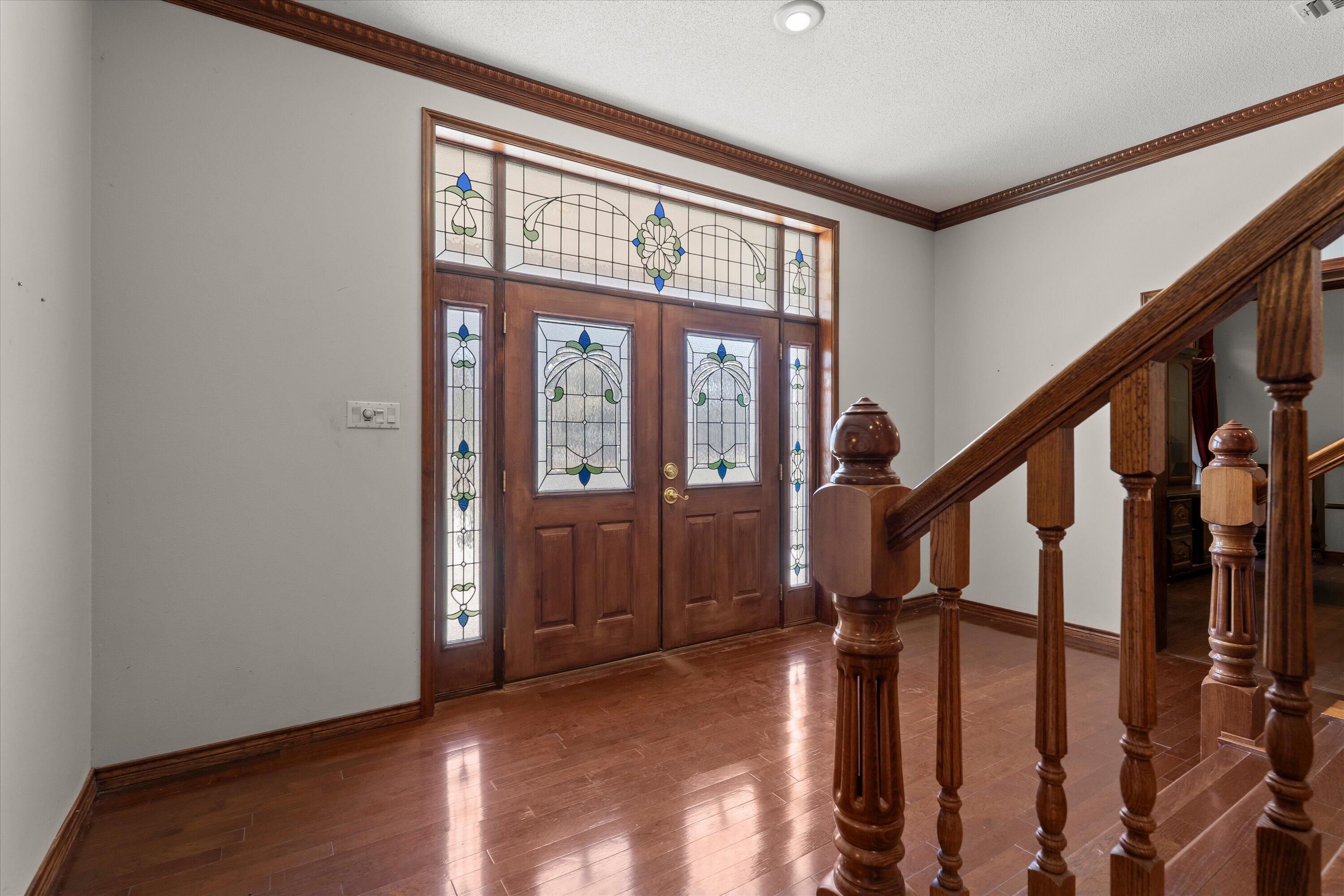 2404 York Avenue Lubbock, TX 79407 - Photo 3 of 88 a view of an entryway with wooden floor and stairs