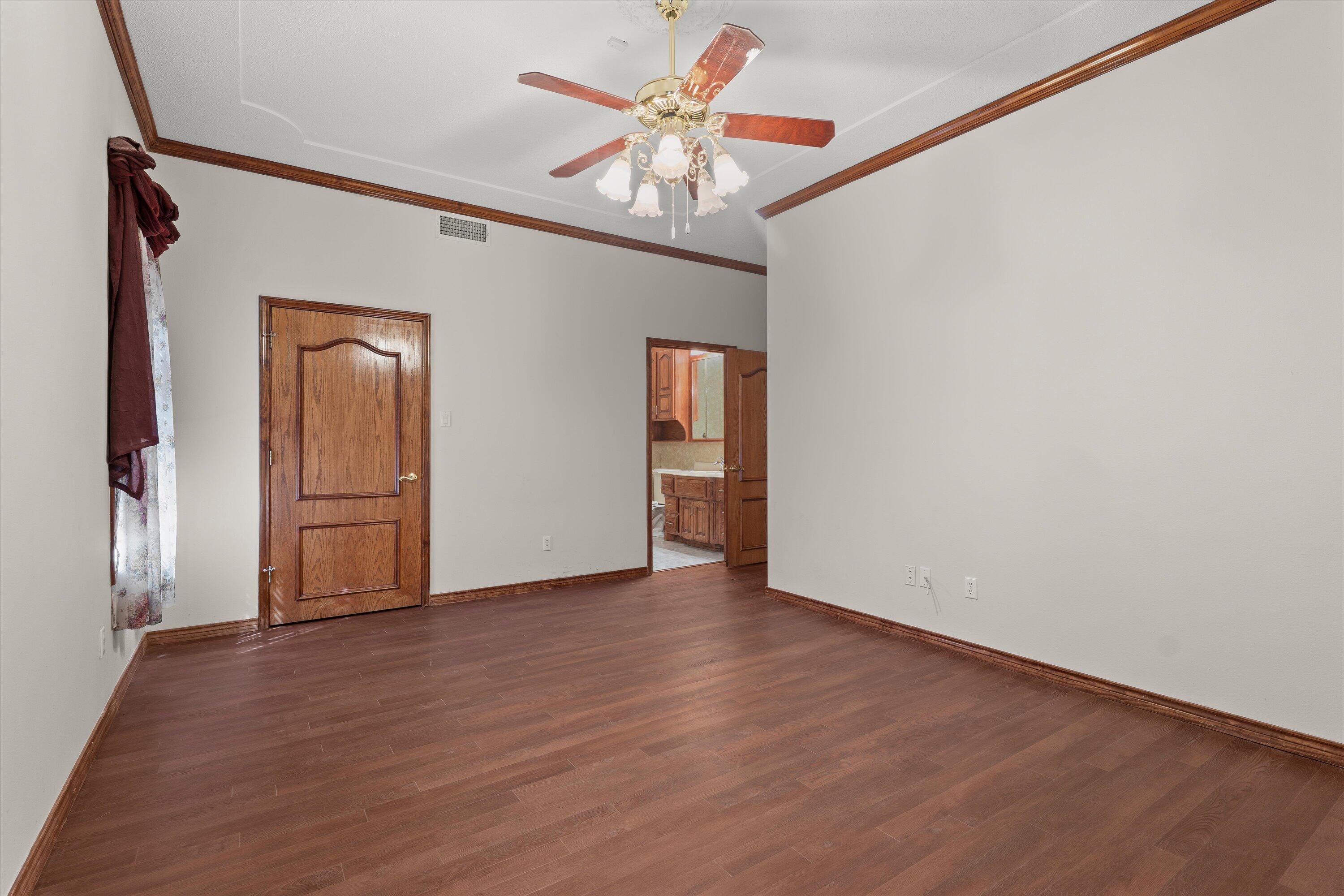 2404 York Avenue Lubbock, TX 79407 - Photo 38 of 88 a view of an empty room with a window and wooden floor