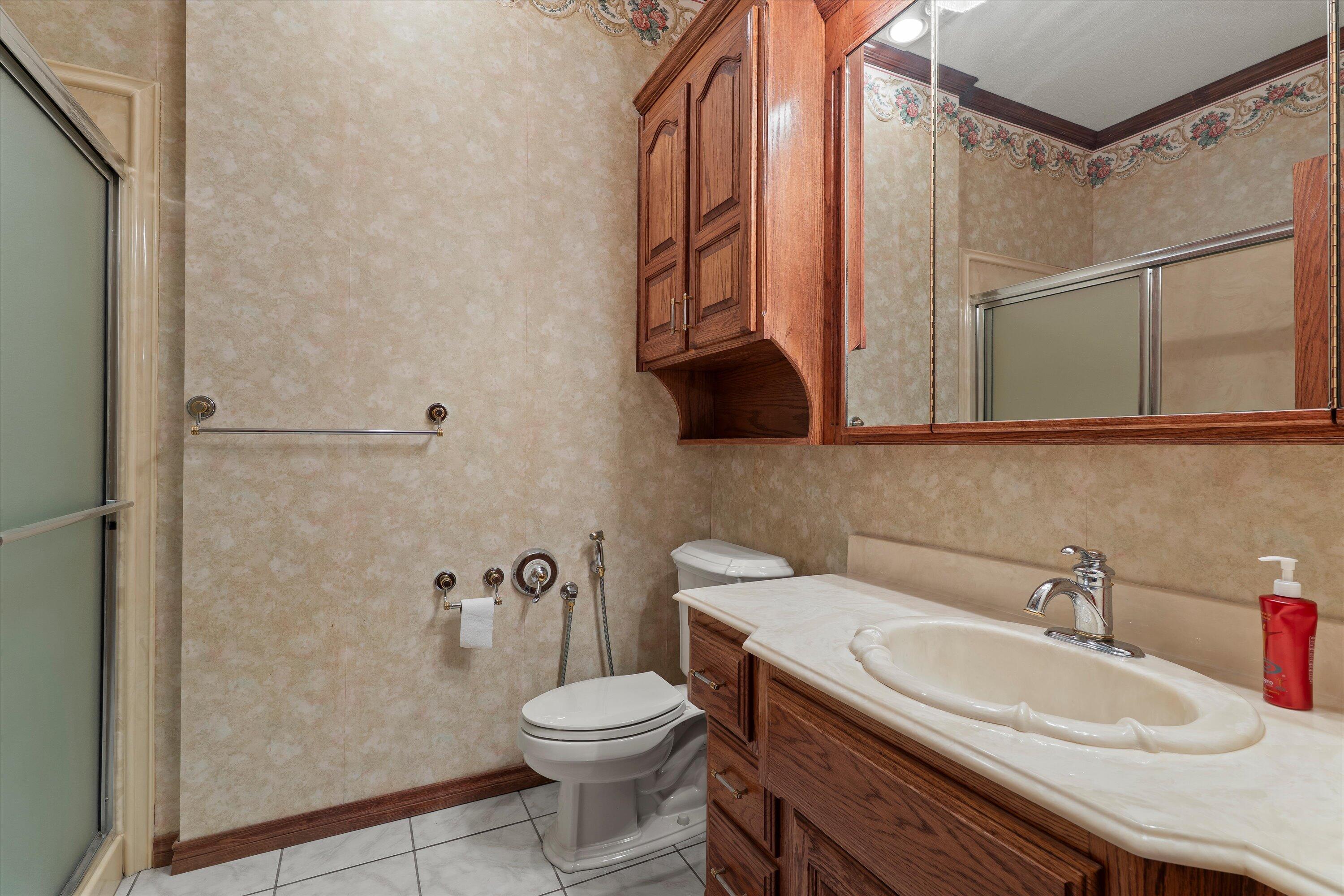 2404 York Avenue Lubbock, TX 79407 - Photo 39 of 88 a bathroom with a sink a toilet and shower