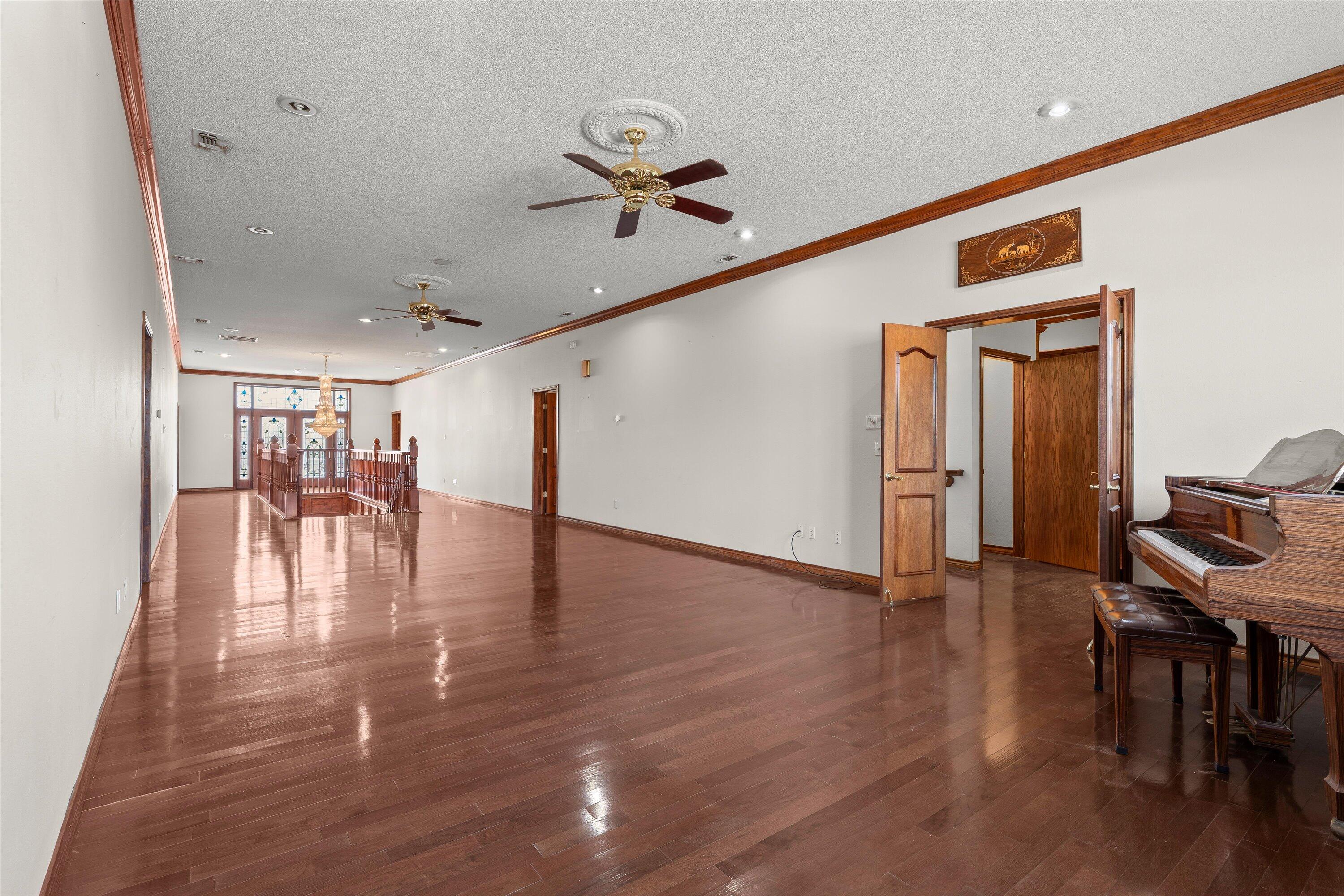2404 York Avenue Lubbock, TX 79407 - Photo 43 of 88 a view of a livingroom with furniture wooden floor a ceiling fan and windows