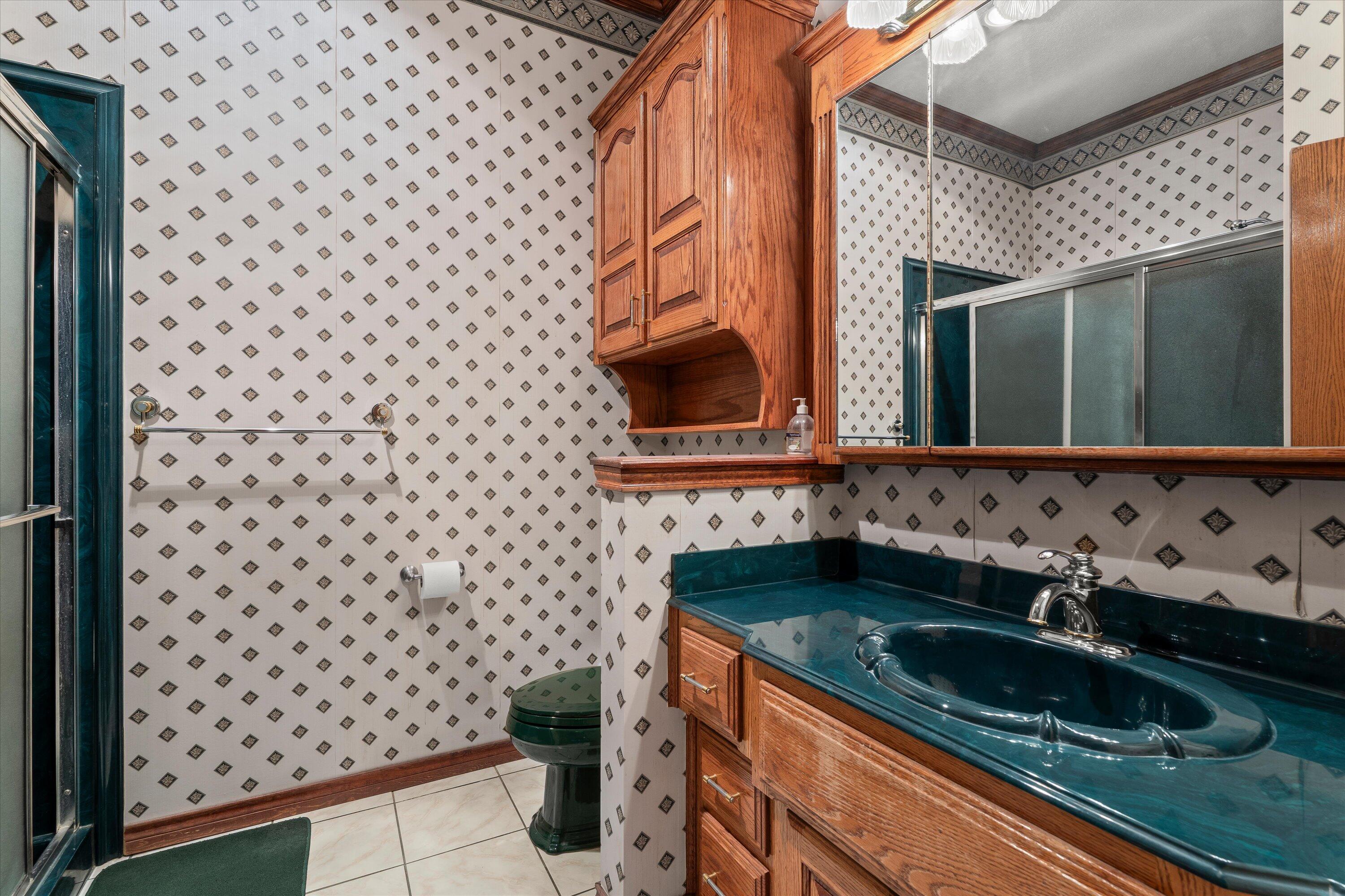 2404 York Avenue Lubbock, TX 79407 - Photo 48 of 88 a bathroom with a sink a toilet and a mirror