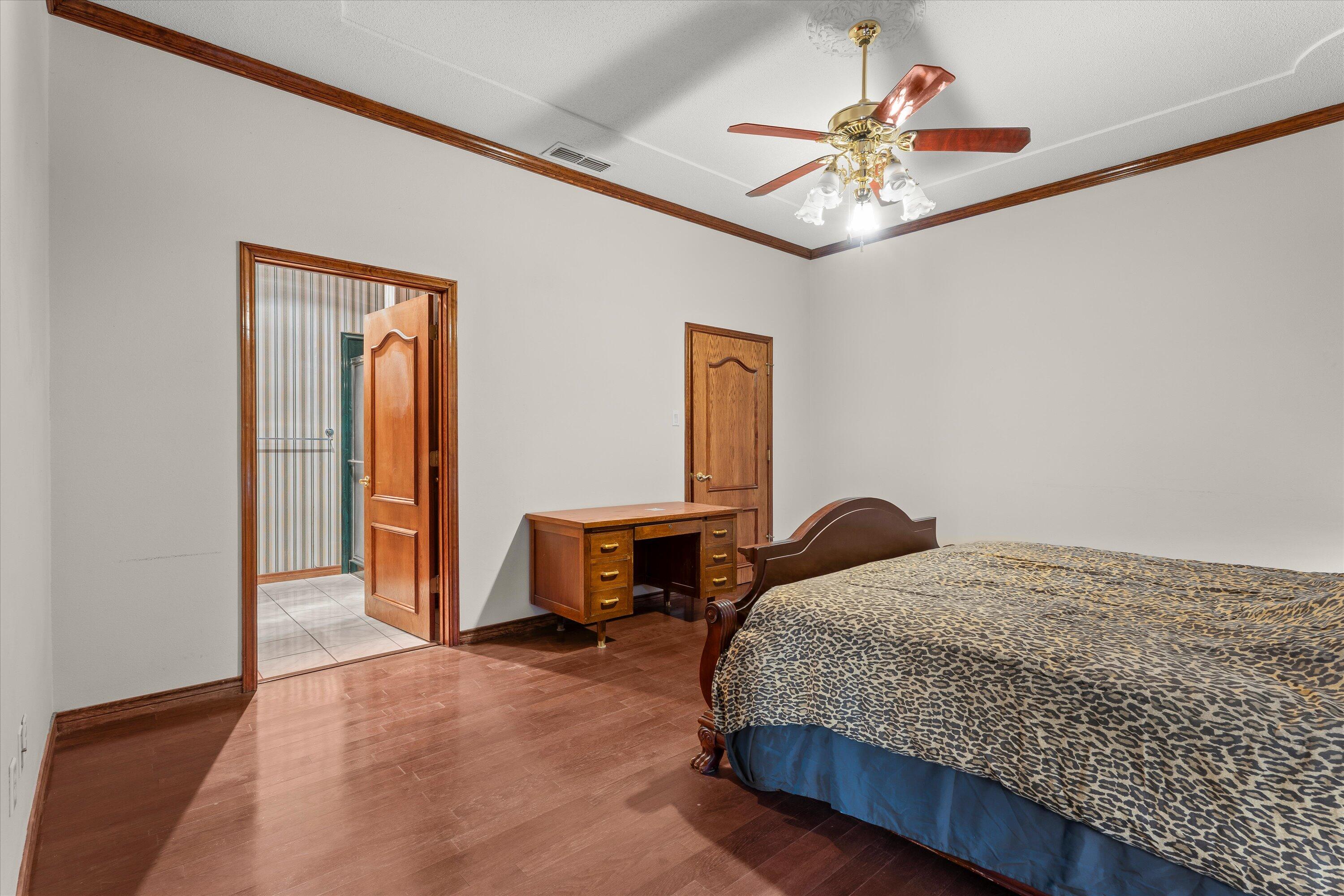 2404 York Avenue Lubbock, TX 79407 - Photo 49 of 88 a bedroom with a bed and a chandelier