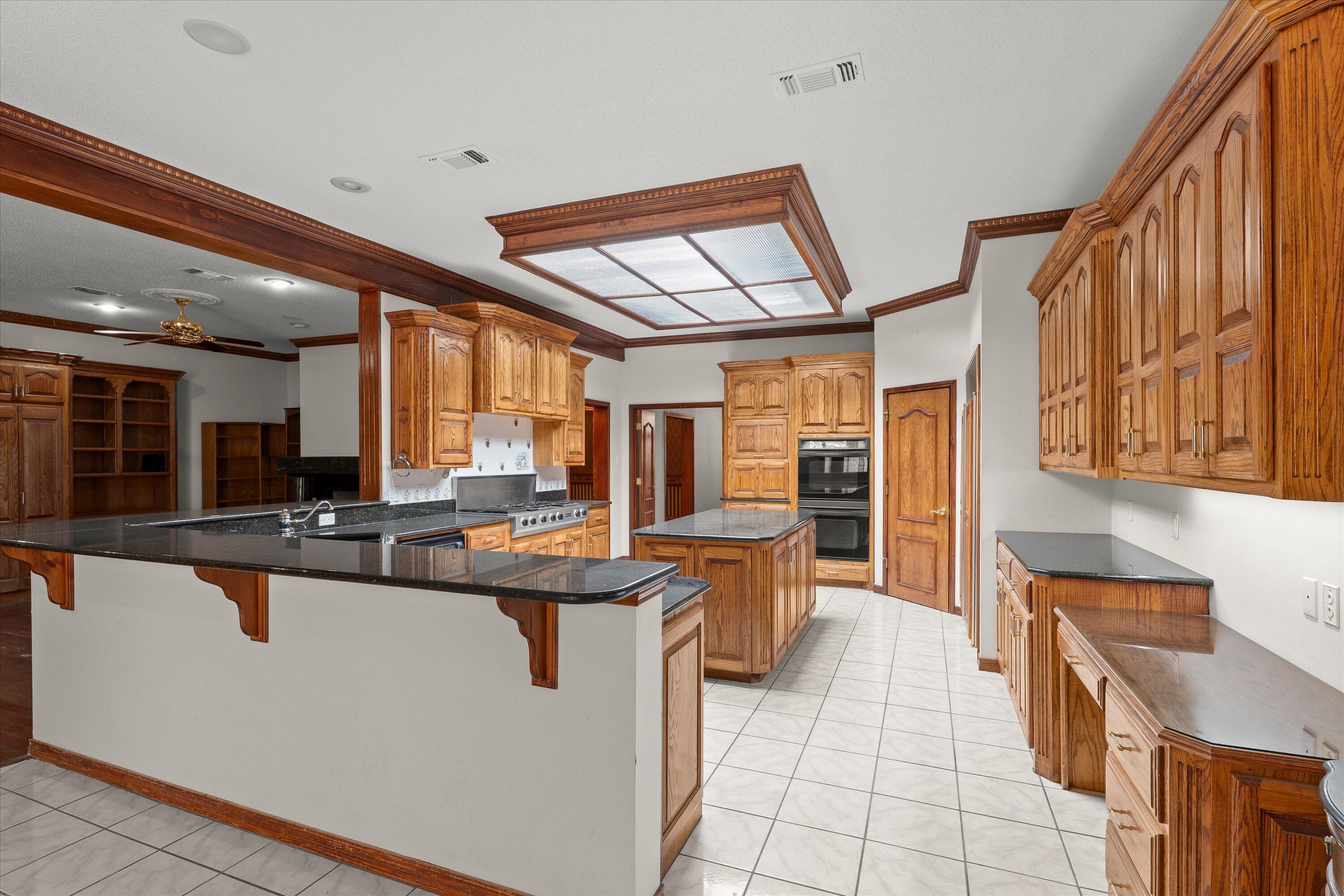2404 York Avenue Lubbock, TX 79407 - Photo 8 of 88 a kitchen with stainless steel appliances granite countertop a sink and a counter top space