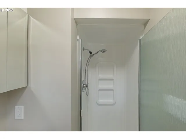 a bathroom with a sink mirror and a window