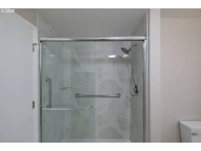 a view of a backyard with wooden fence