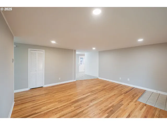 a kitchen with stainless steel appliances granite countertop a refrigerator a stove and a wooden floors