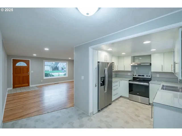 a kitchen with a sink stainless steel appliances and cabinets