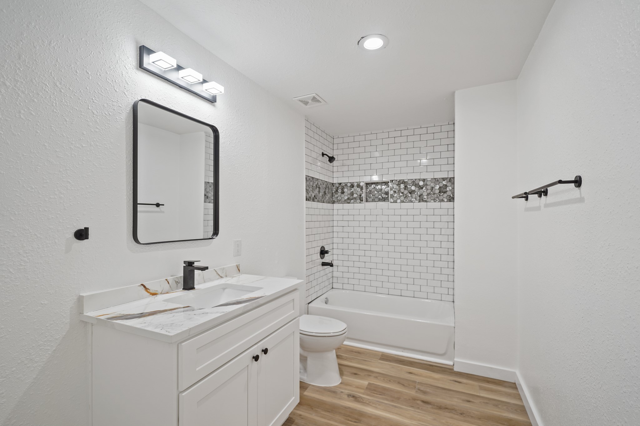 4154 Erby Street Houston, TX 77087 - Photo 14 of 36 a bathroom with a granite countertop sink a toilet a mirror and shower