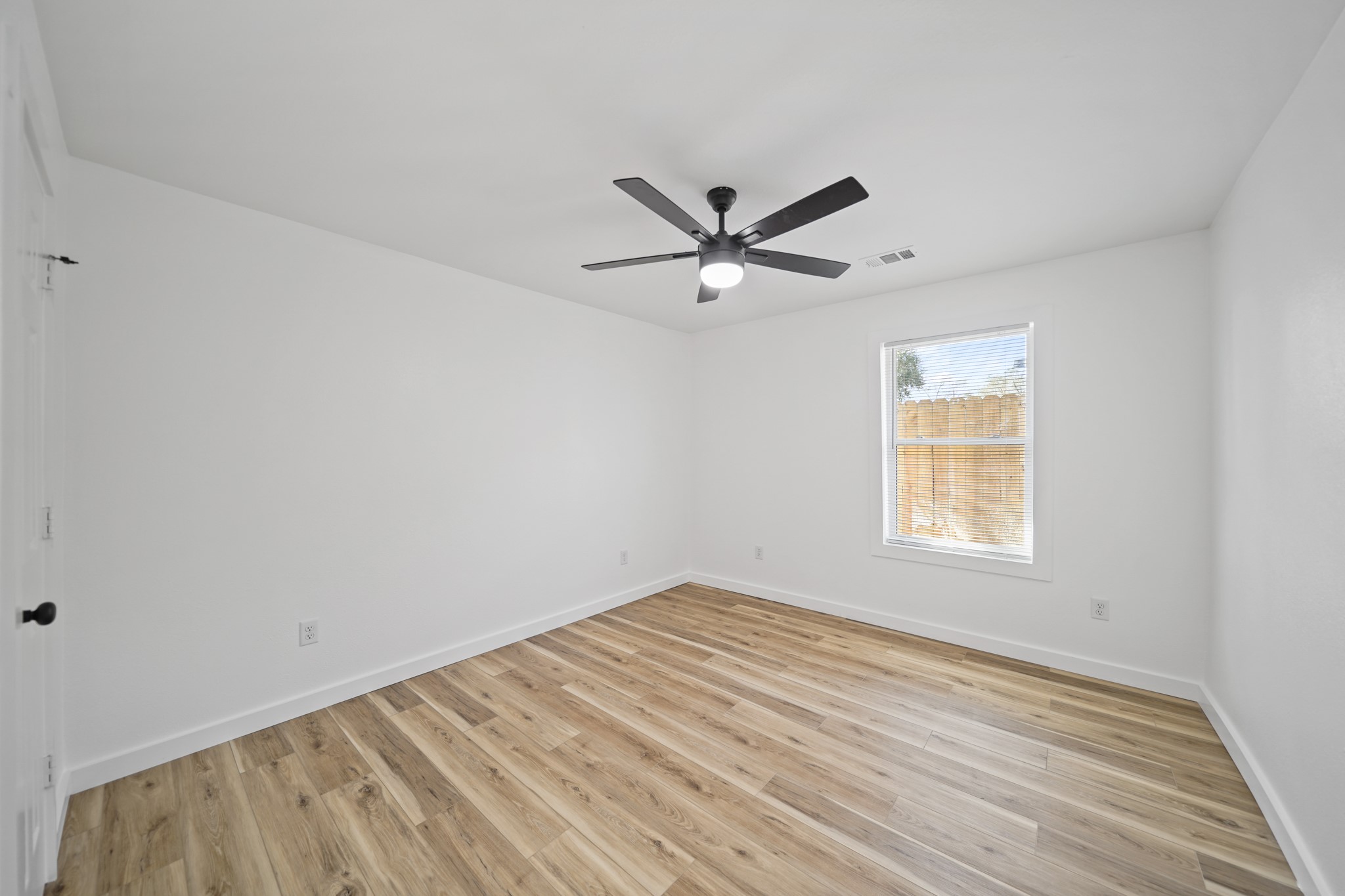 4154 Erby Street Houston, TX 77087 - Photo 15 of 36 an empty room with a window and a fan