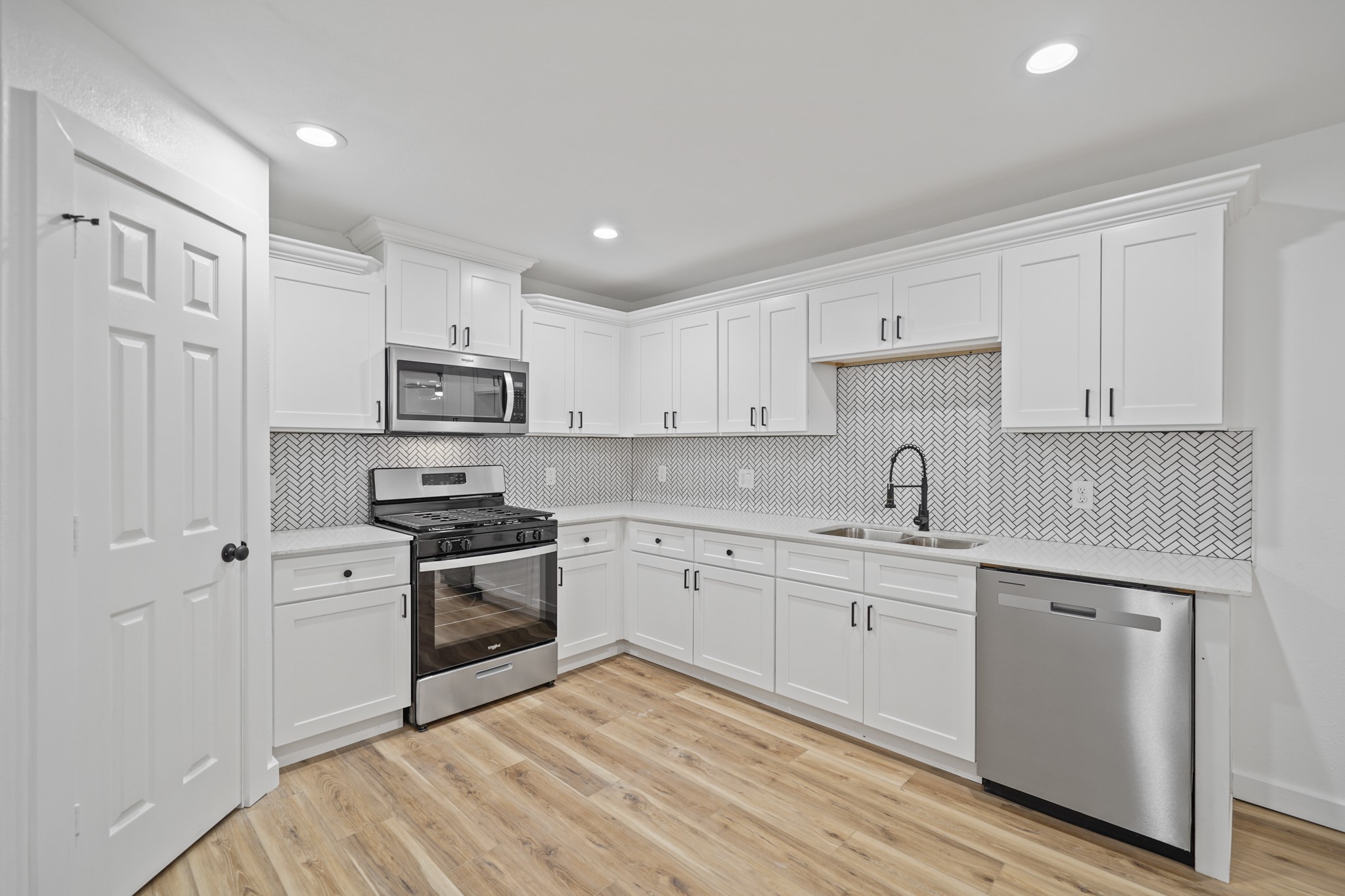 4154 Erby Street Houston, TX 77087 - Photo 26 of 36 a kitchen with cabinets stainless steel appliances and sink