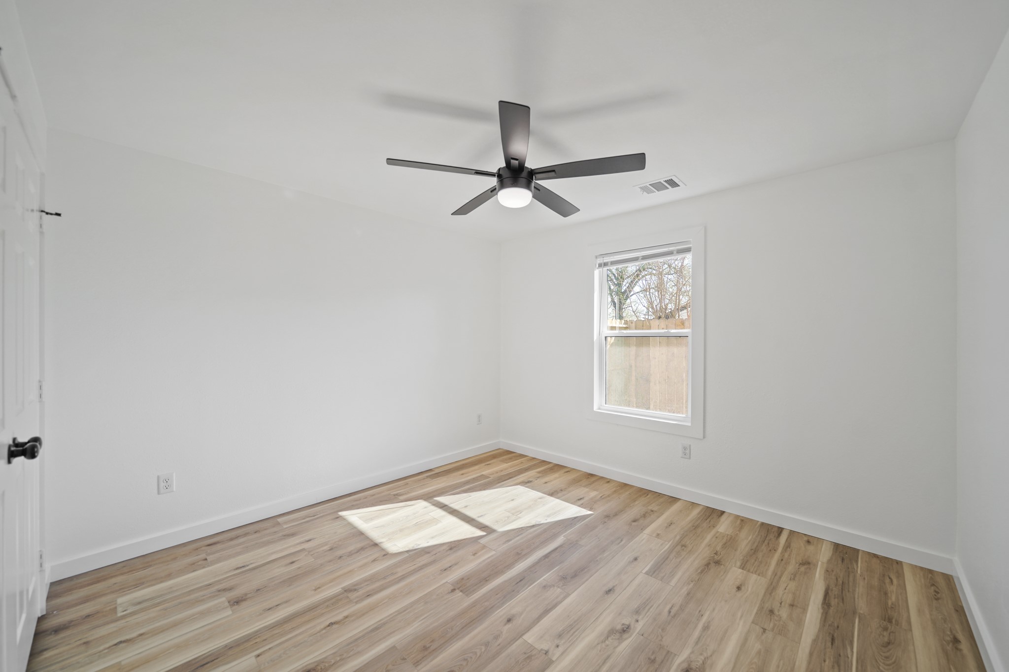 4154 Erby Street Houston, TX 77087 - Photo 28 of 36 a view of empty room with wooden floor and fan