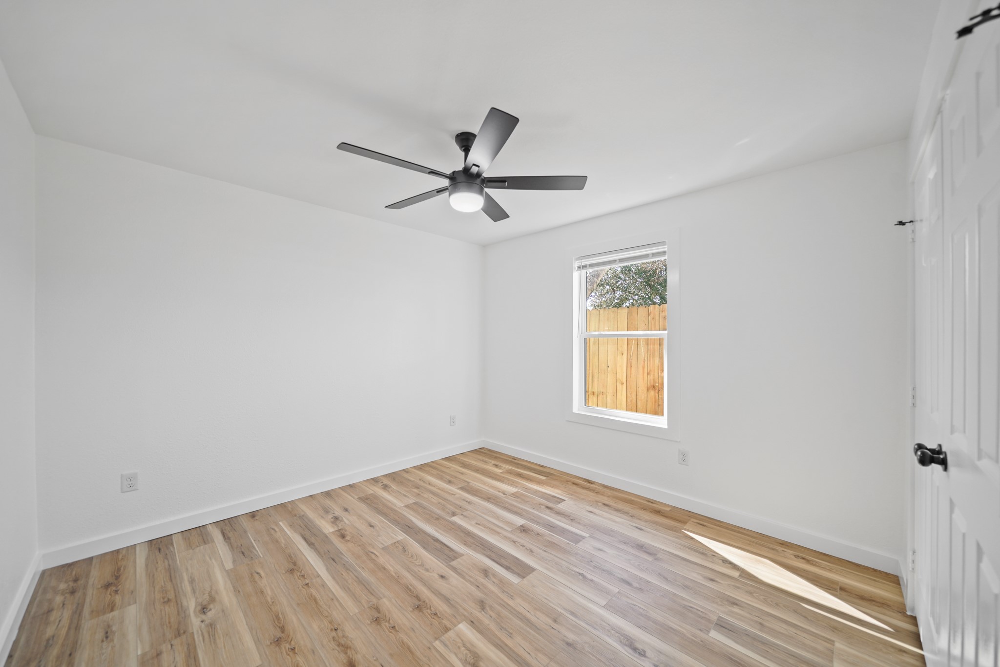 4154 Erby Street Houston, TX 77087 - Photo 30 of 36 a view of empty room with wooden floor and fan