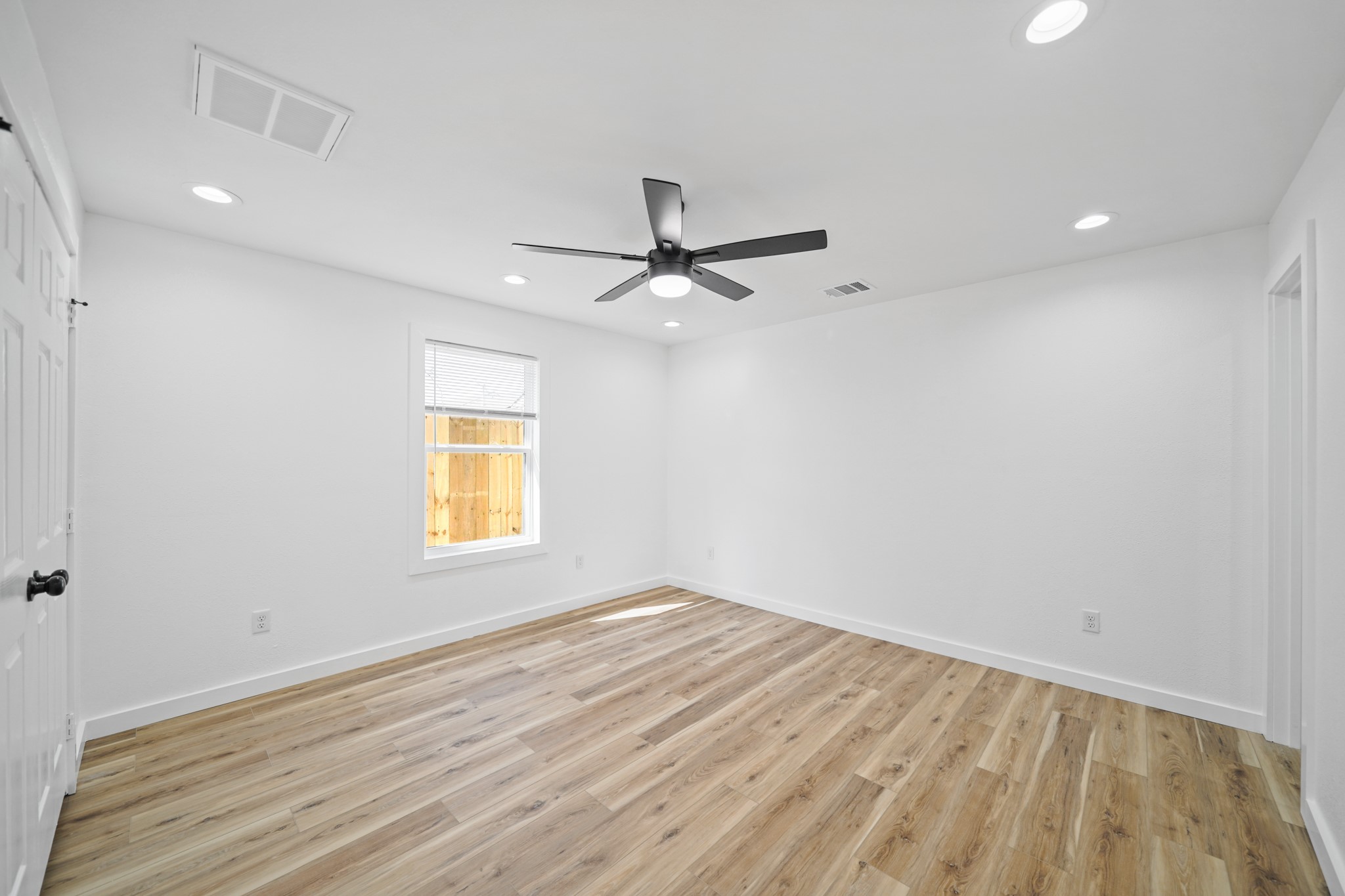 4154 Erby Street Houston, TX 77087 - Photo 31 of 36 wooden floor in an empty room with a window