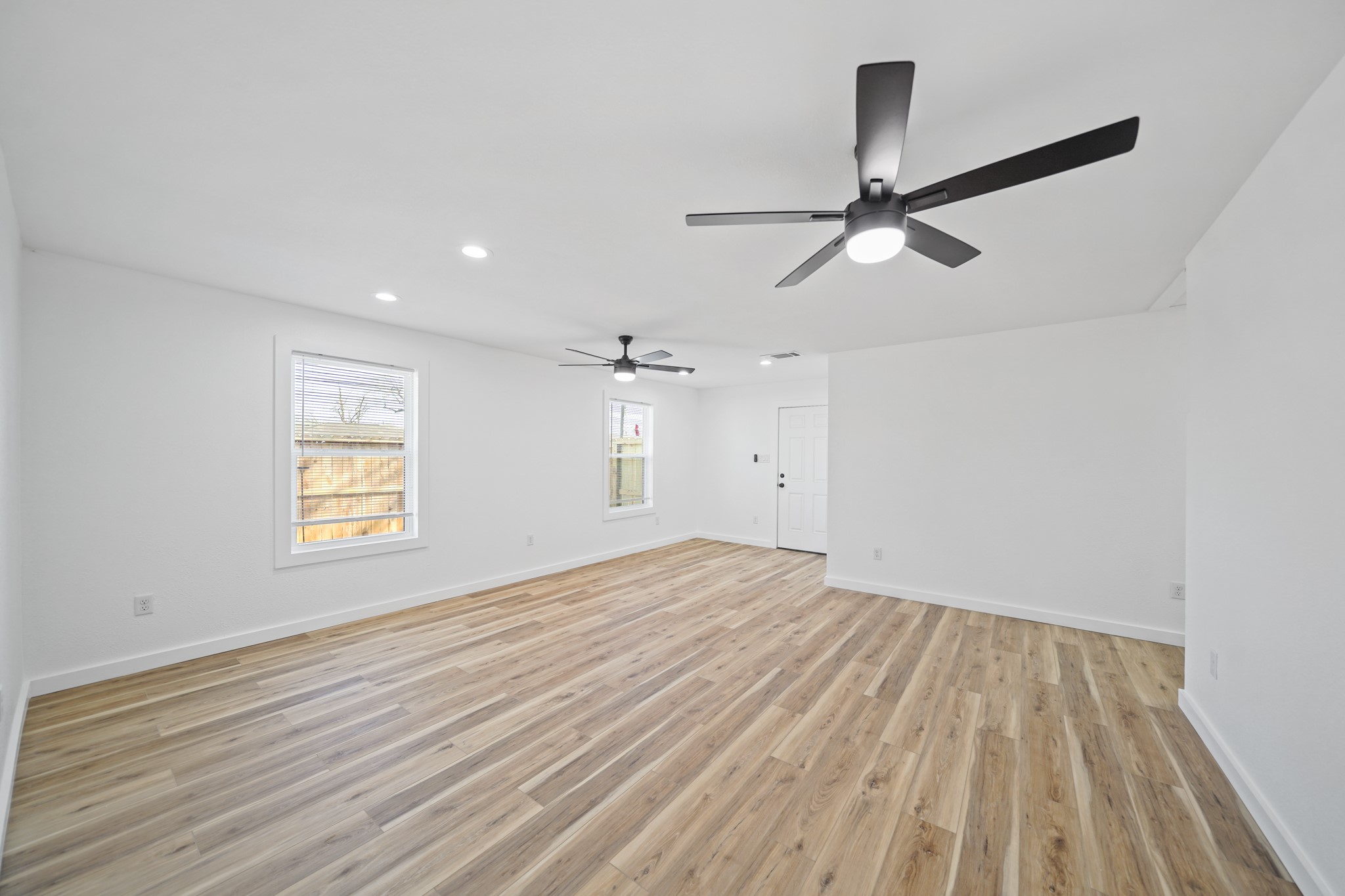4154 Erby Street Houston, TX 77087 - Photo 34 of 36 a view of empty room with wooden floor and fan