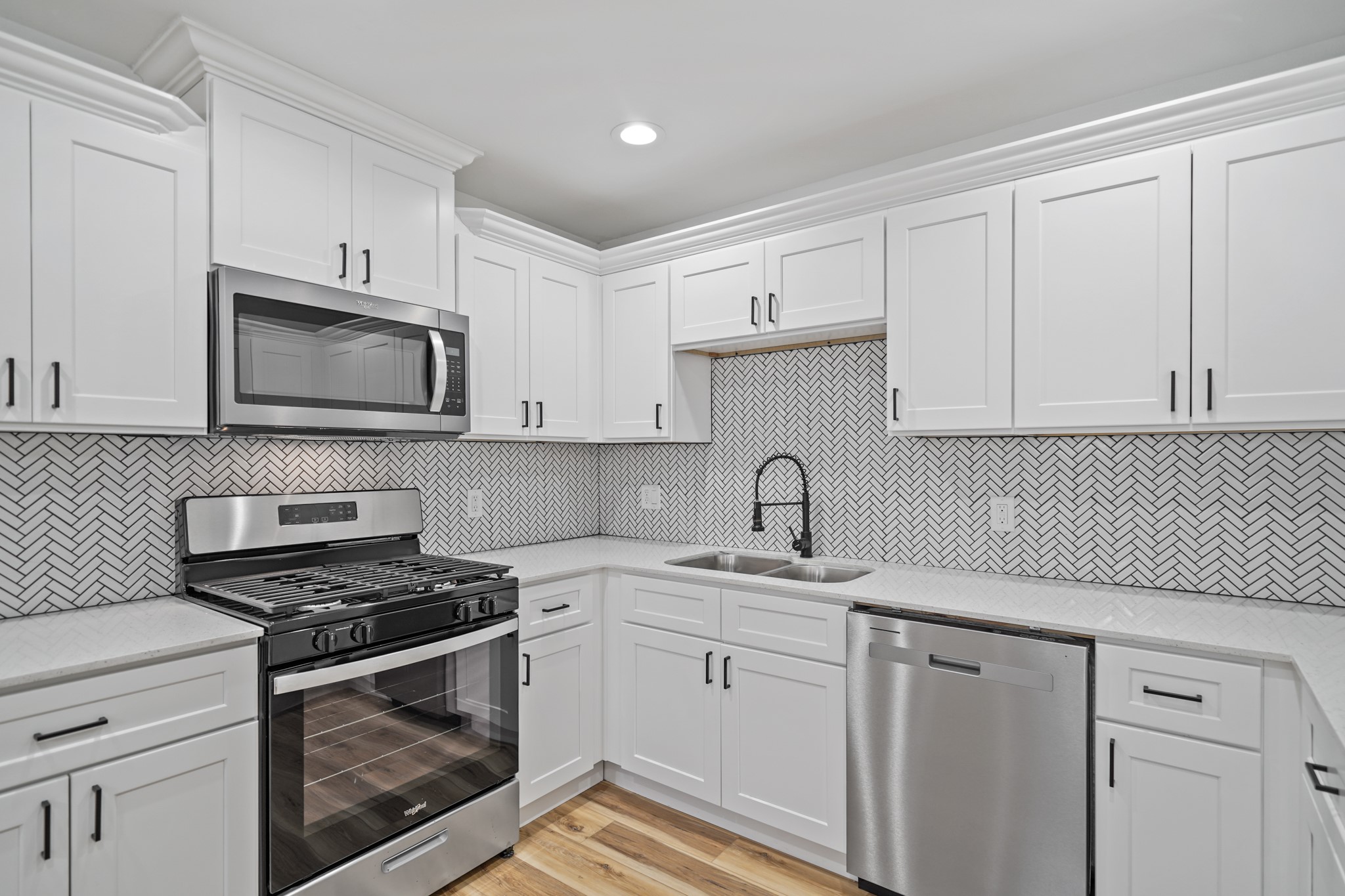 4154 Erby Street Houston, TX 77087 - Photo 10 of 36 a kitchen with white cabinets stainless steel appliances and sink