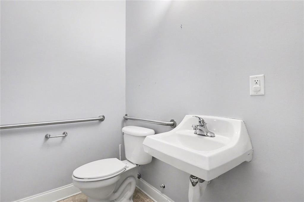 3745 Cherokee Street Northwest Kennesaw, GA 30144 - Photo 18 of 24 a white toilet sitting next to a white sink