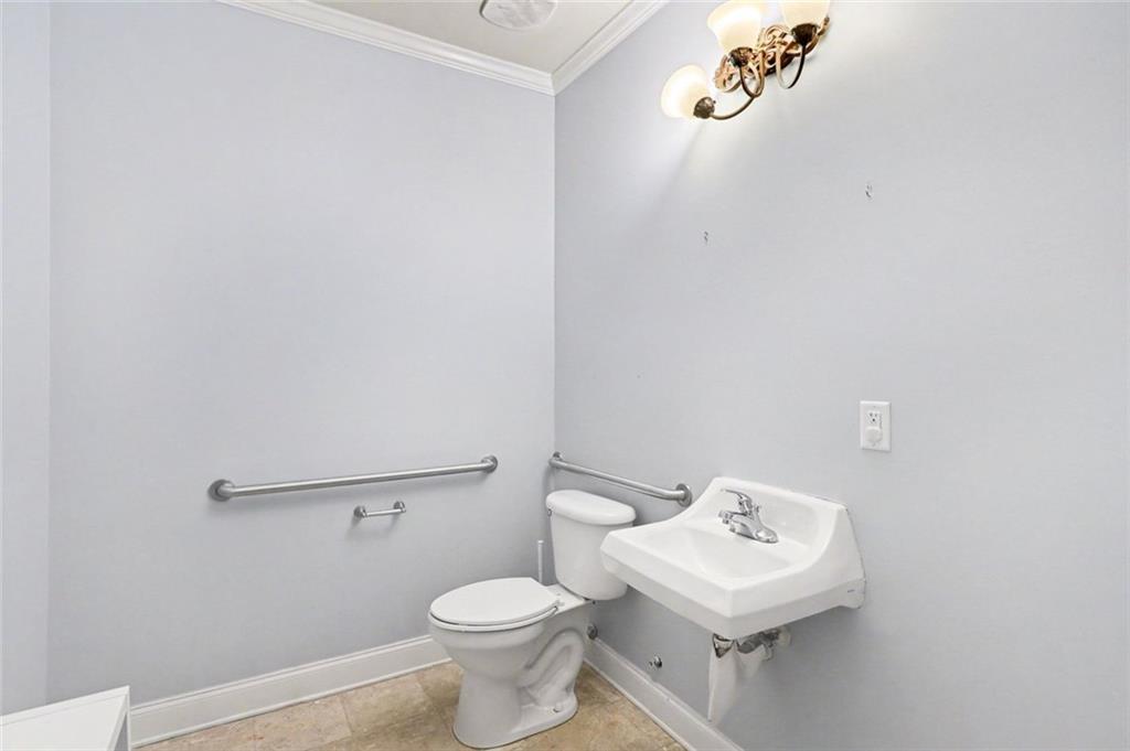 3745 Cherokee Street Northwest Kennesaw, GA 30144 - Photo 19 of 24 a white toilet sitting next to a bathroom sink