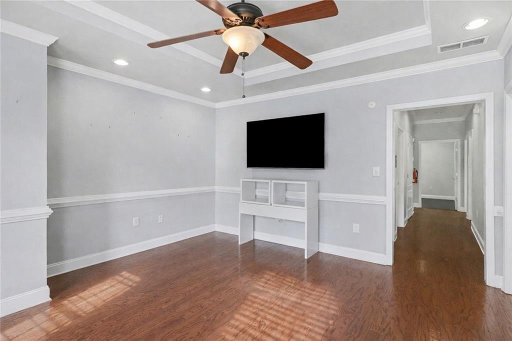 3745 Cherokee Street Northwest Kennesaw, GA 30144 - Photo 5 of 24 a view of a livingroom with wooden floor and a ceiling fan