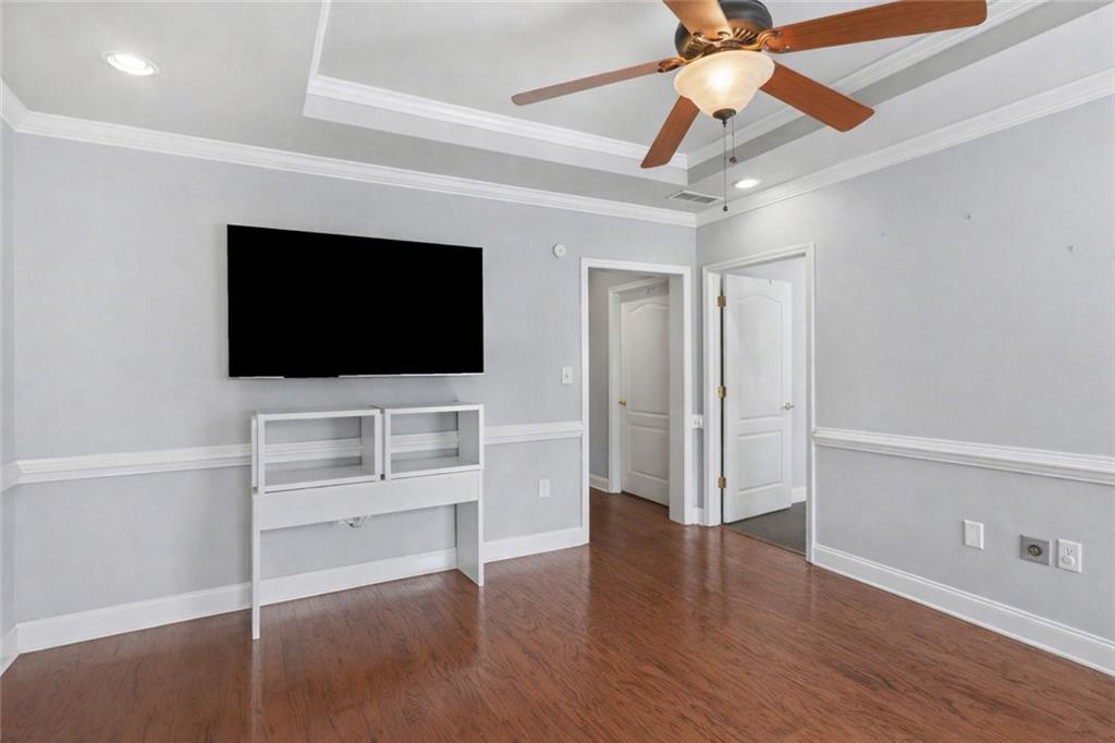 3745 Cherokee Street Northwest Kennesaw, GA 30144 - Photo 6 of 24 a view of a livingroom with wooden floor a ceiling fan and windows