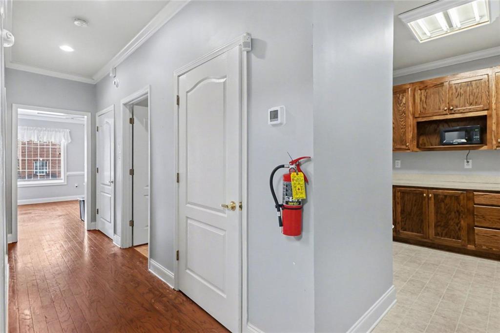 3745 Cherokee Street Northwest Kennesaw, GA 30144 - Photo 8 of 24 a view of a hallway with wooden floor and workspace