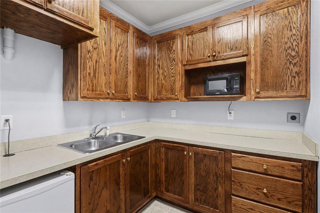 3745 Cherokee Street Northwest Kennesaw, GA 30144 - Photo 9 of 24 a kitchen with stainless steel appliances wooden cabinets and a sink
