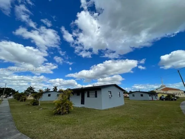 a view of a garden with a building in the background