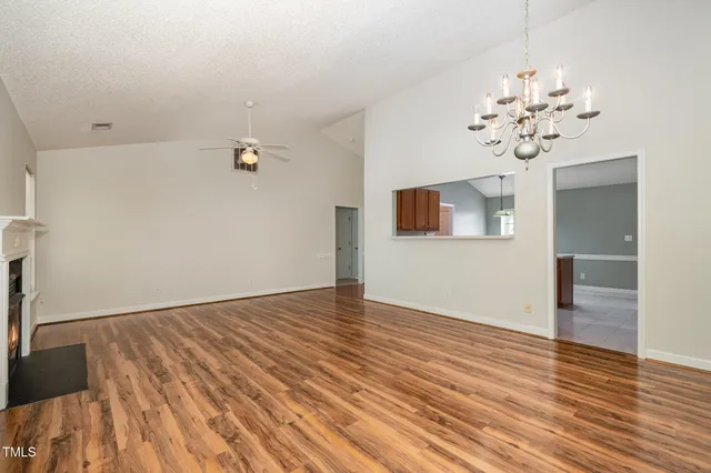 a view of a room with wooden floor and windows
