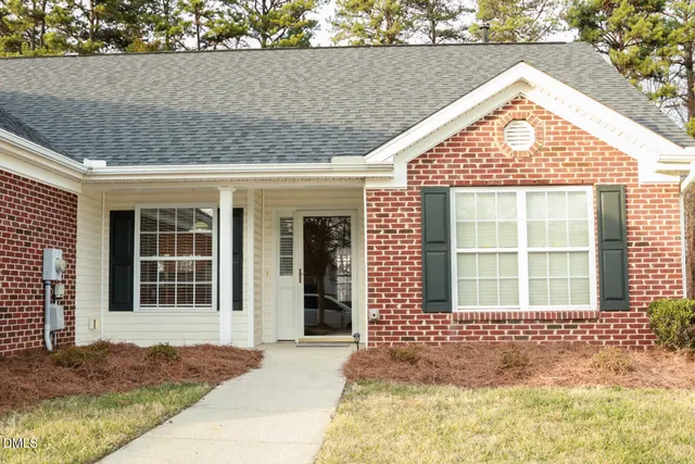 a house that has a tree in front of it
