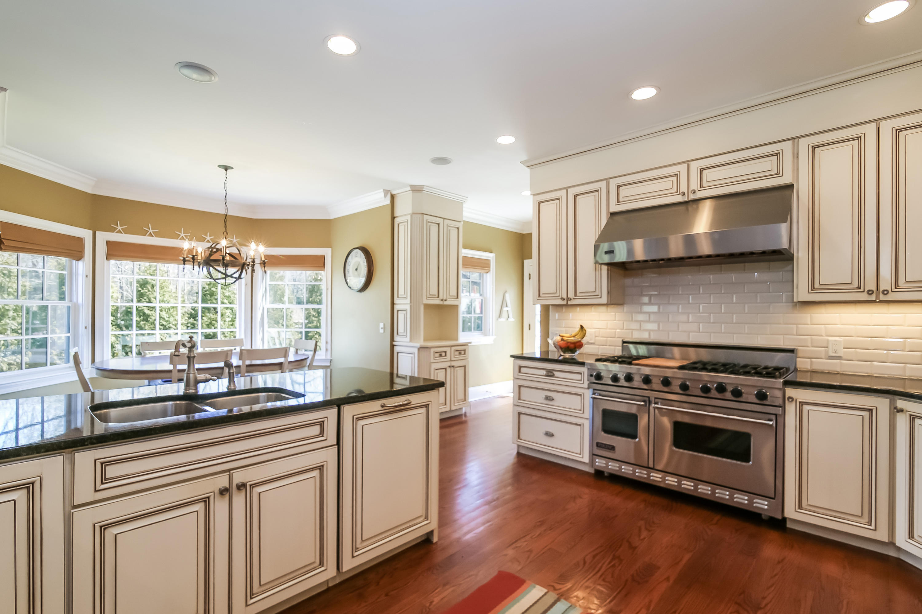 3 Bishops Gate Road Darien, CT 06820 - Photo 17 of 61 a kitchen with stainless steel appliances a stove sink and microwave