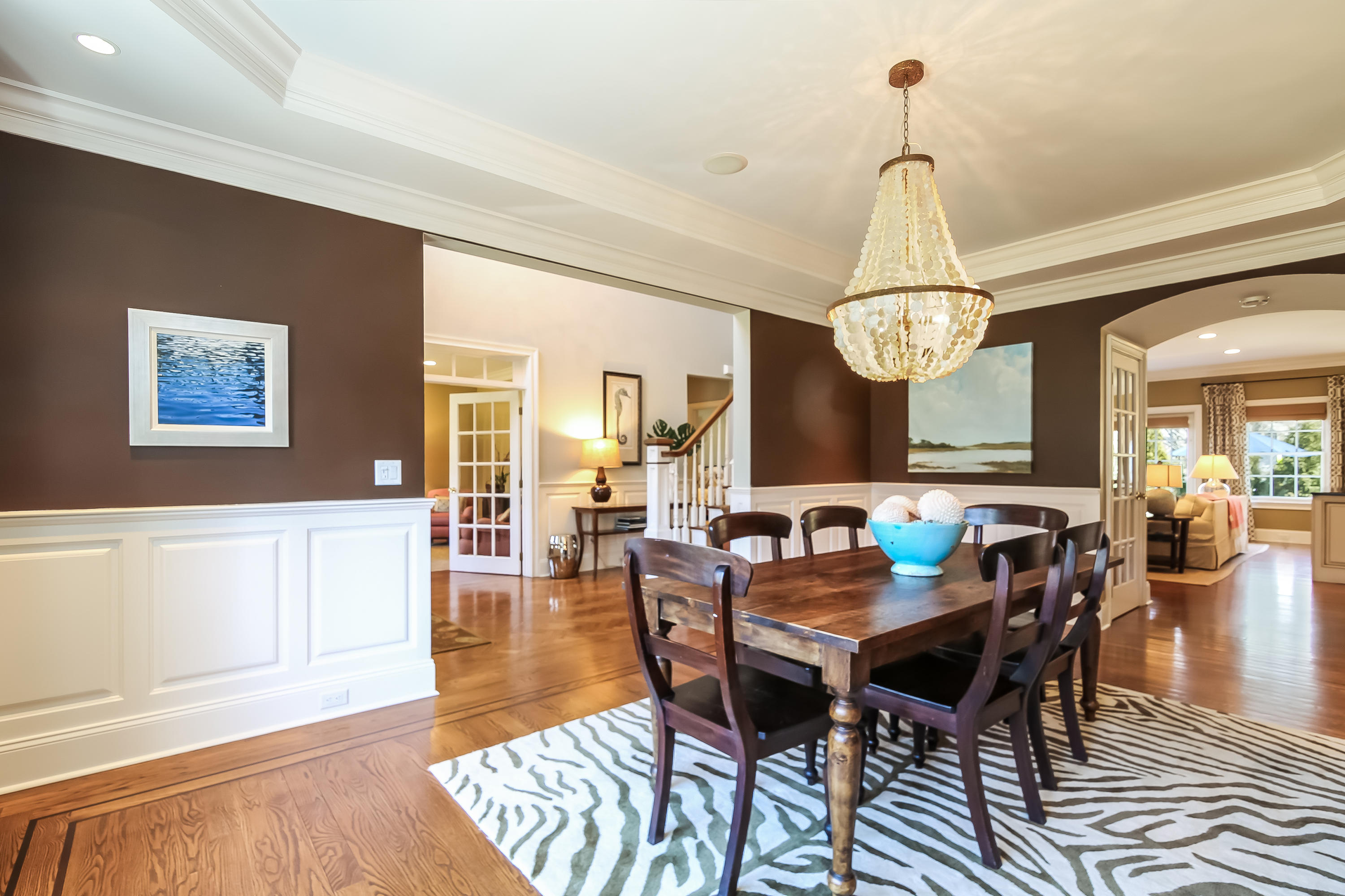 3 Bishops Gate Road Darien, CT 06820 - Photo 22 of 61 a view of a dining room with furniture a chandelier and wooden floor