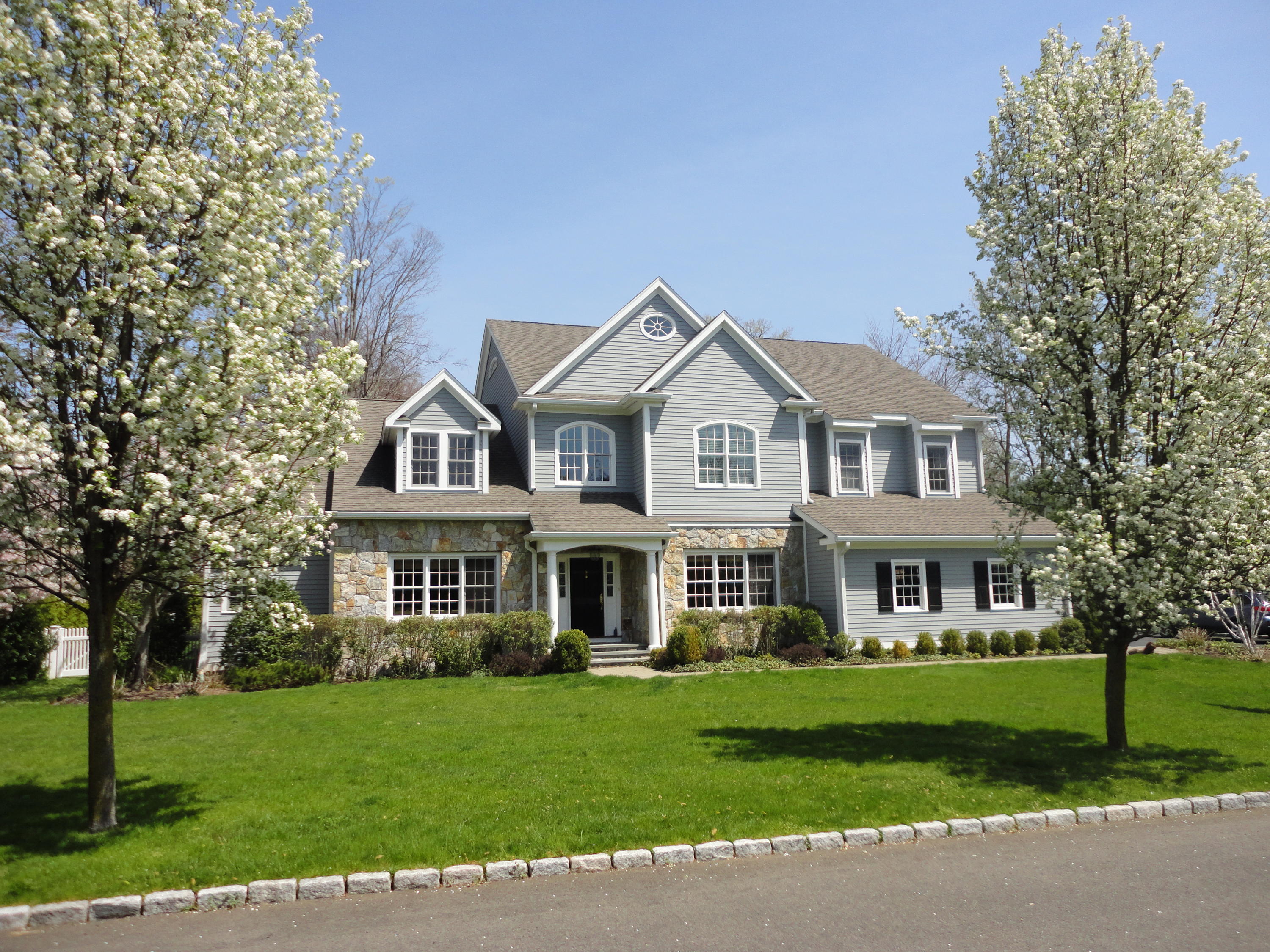 3 Bishops Gate Road Darien, CT 06820 - Photo 5 of 61 a front view of a house with a yard