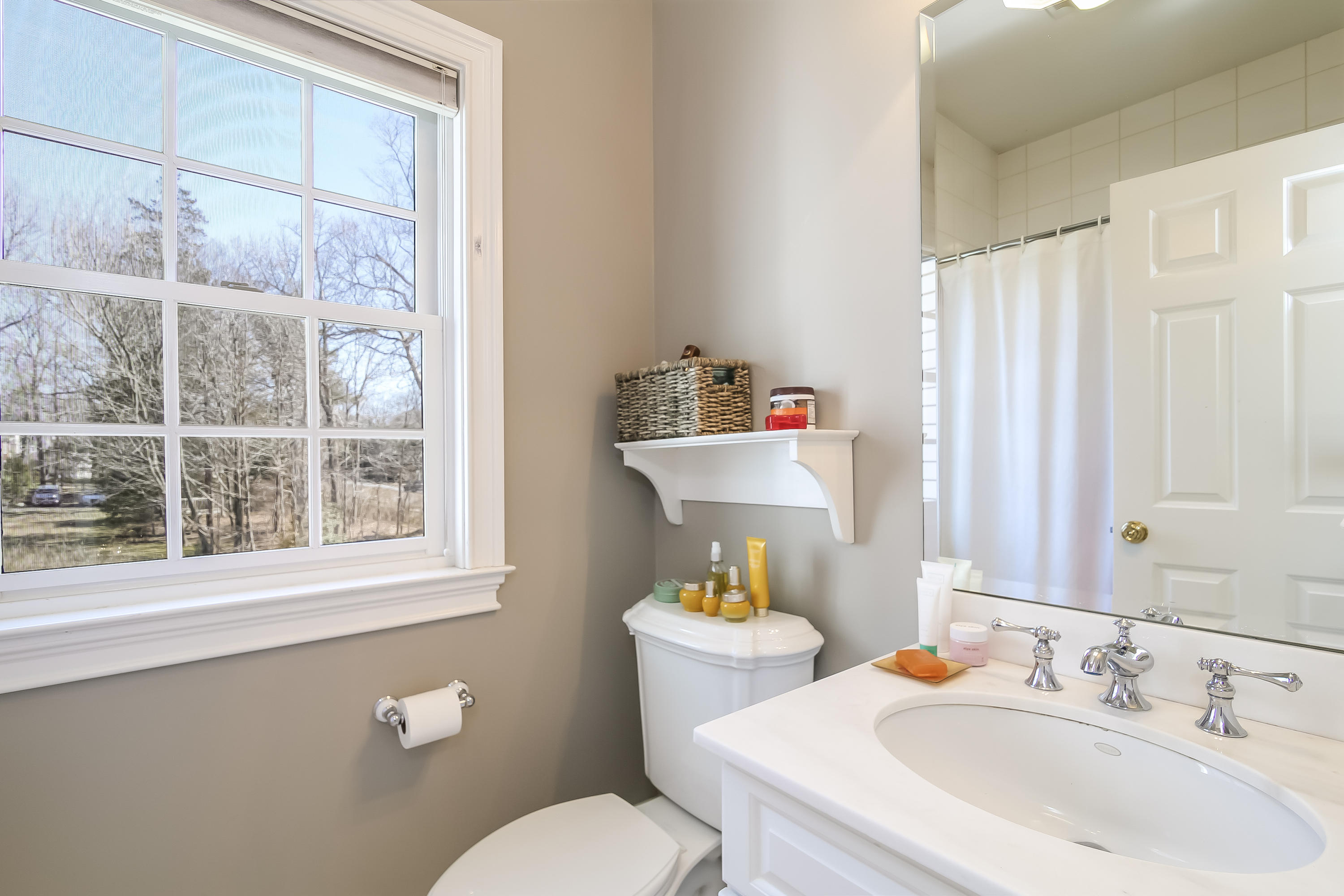 3 Bishops Gate Road Darien, CT 06820 - Photo 43 of 61 a bathroom with a sink mirror and toilet
