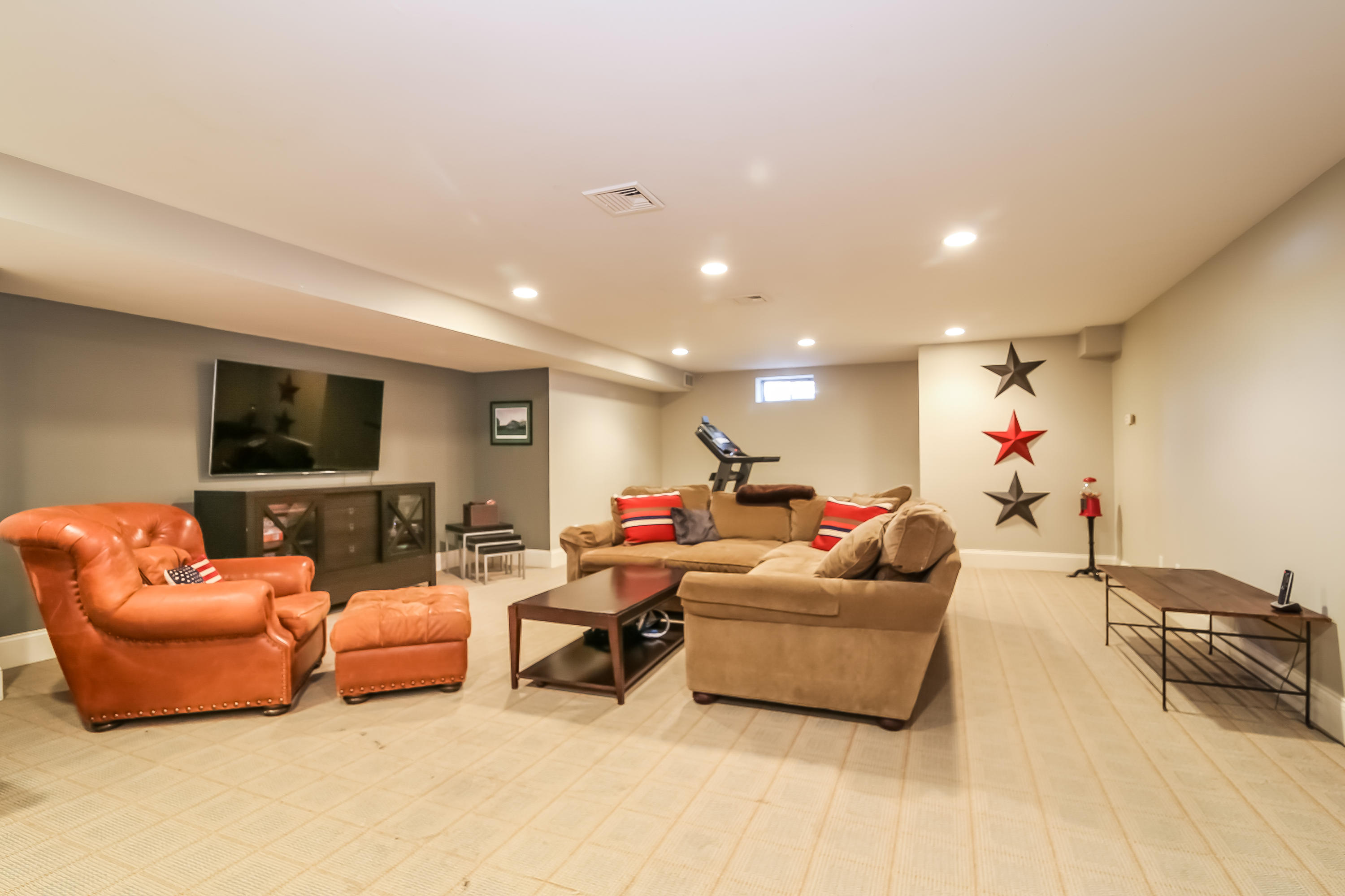 3 Bishops Gate Road Darien, CT 06820 - Photo 48 of 61 a living room with furniture and a flat screen tv