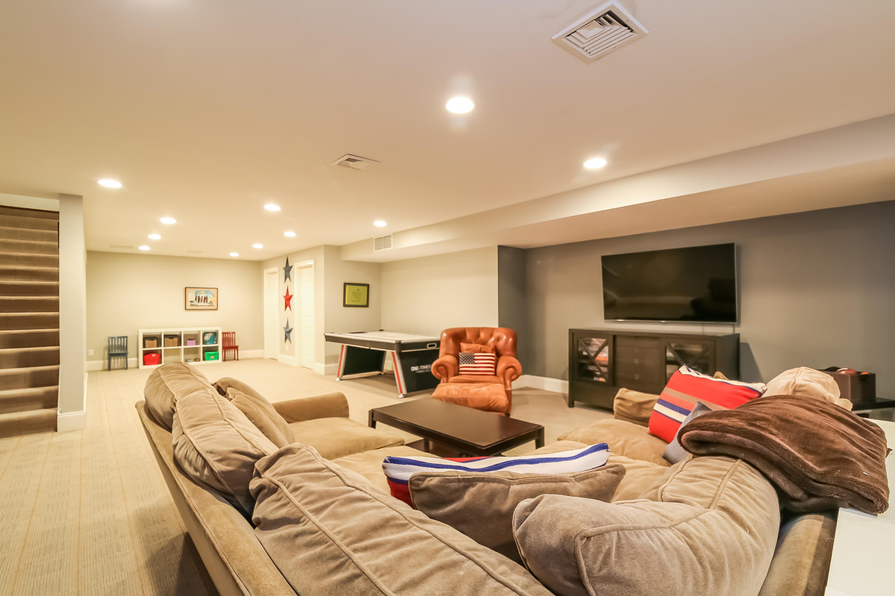 3 Bishops Gate Road Darien, CT 06820 - Photo 49 of 61 a living room with furniture and a flat screen tv