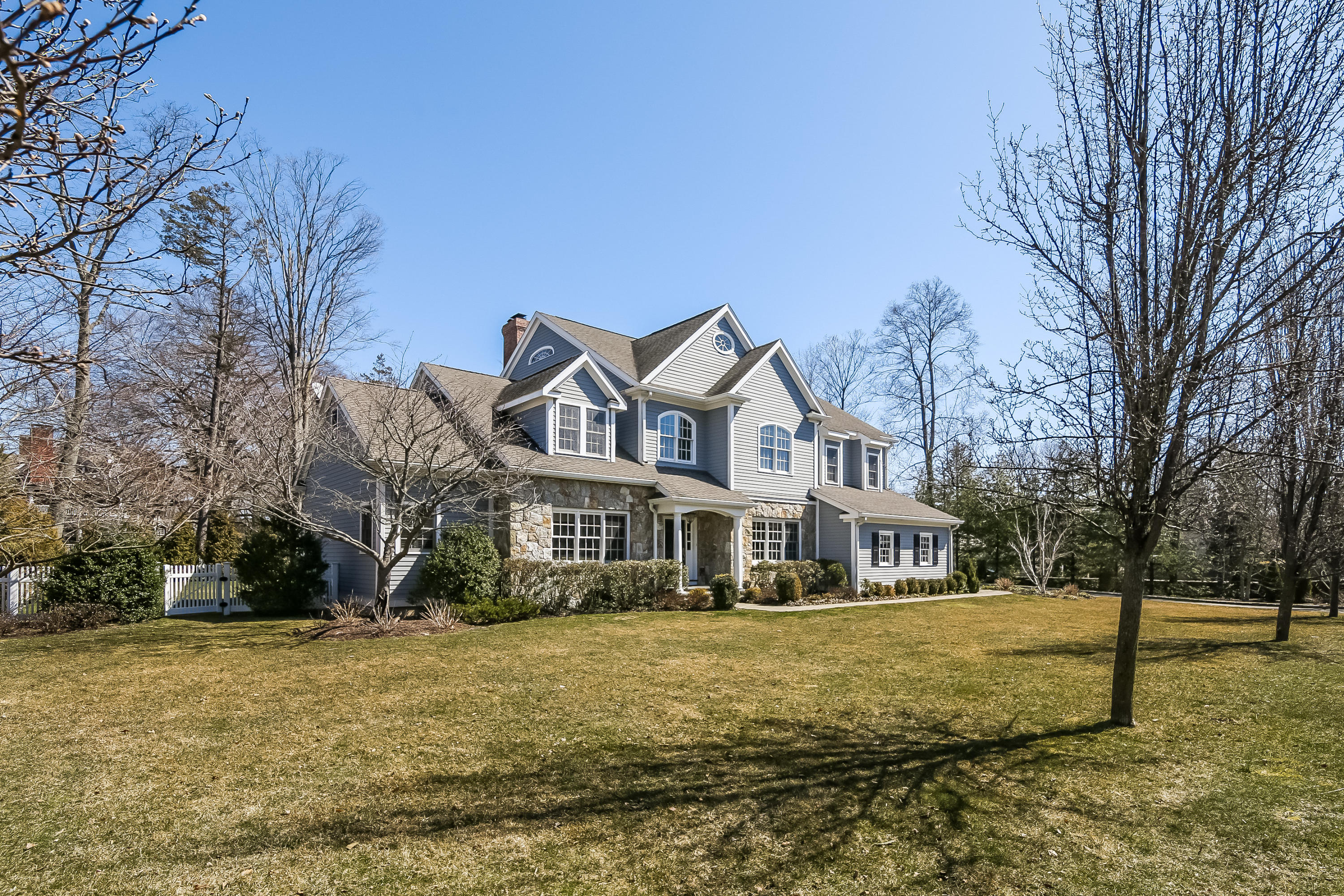 3 Bishops Gate Road Darien, CT 06820 - Photo 58 of 61 a front view of a house with a yard
