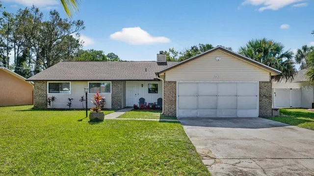 a front view of a house with a yard and porch