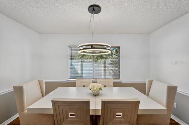 a view of a dining room with furniture and chandelier