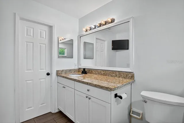 a view of bathroom with a sink and mirror