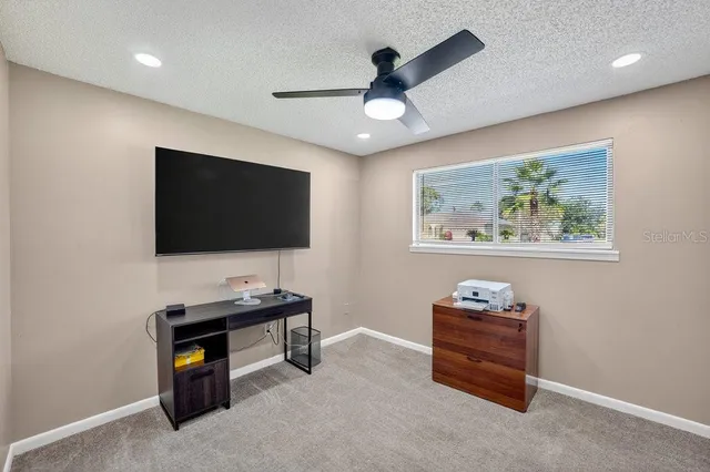 a view of an empty room with shelves and a bookshelf