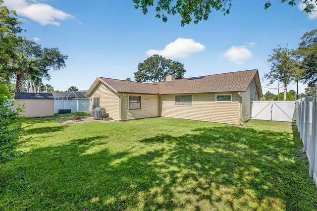 a view of backyard with swimming pool and seating space